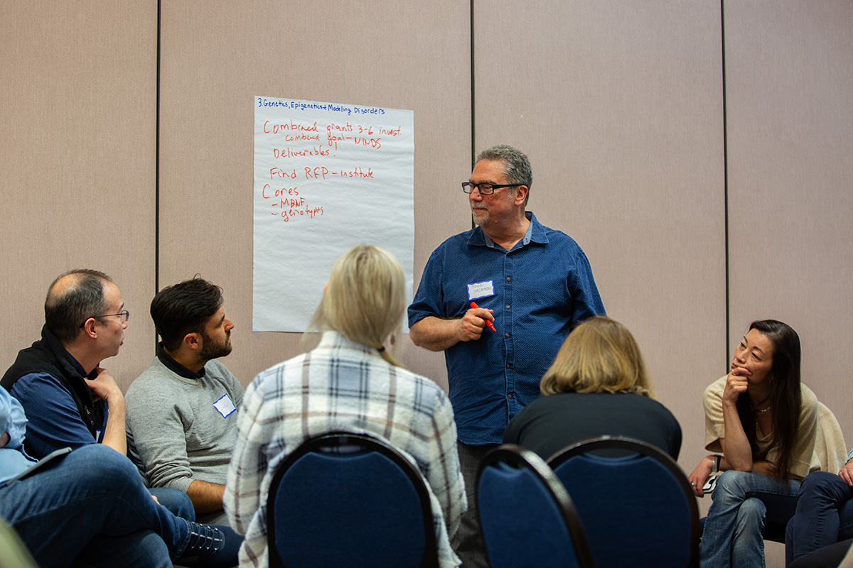 A group of researchers brainstorm ideas during a lively conversation.