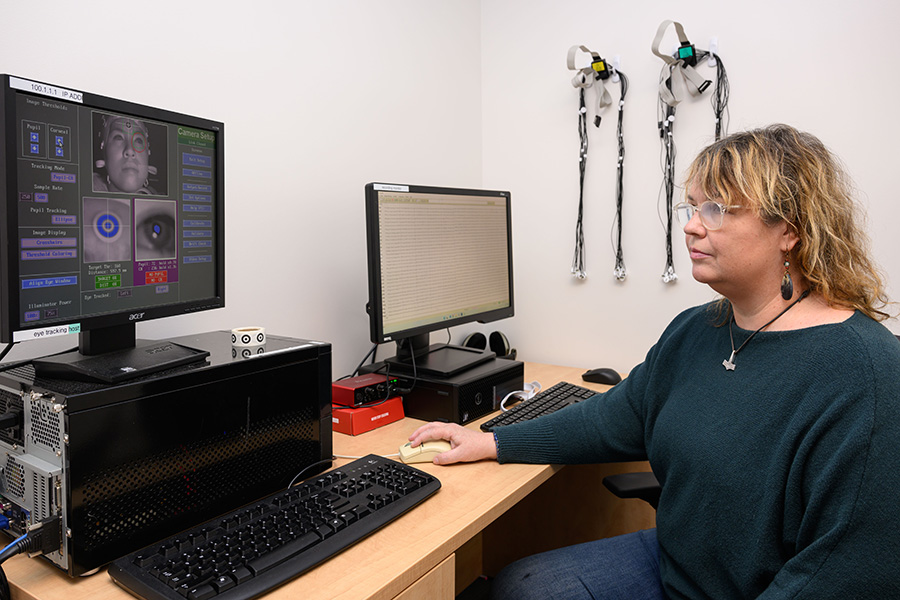 A lab manager monitors the results of research equipment in the Electrophysiology Resource Laboratory.