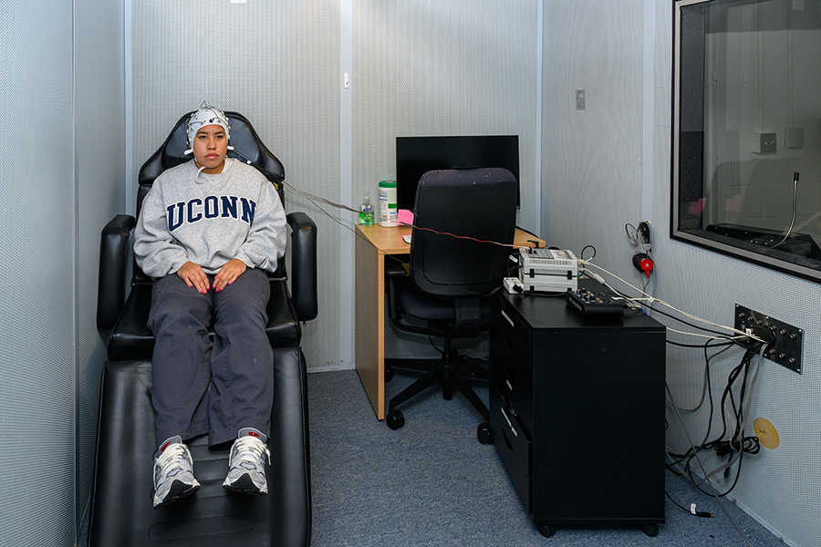 A person in the sound booth facility in the Electrophysiology Resource Laboratory.